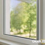 Установленная рамочная москитная сетка на белом окне ПВХ — вид через сетку на зелень, Минск